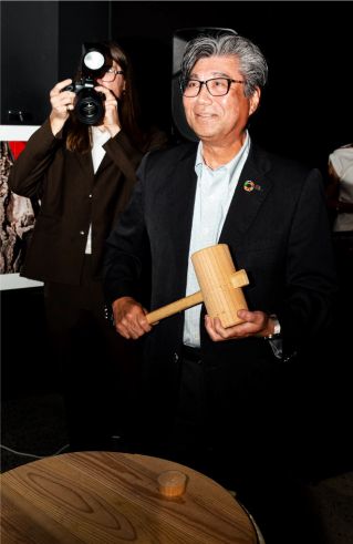 The president of Ricoh Imaging Company Ltd, Yasutomo Mori, prepares for the ceremonial breaking of the sake barrel at the opening of GR Space Brisbane.