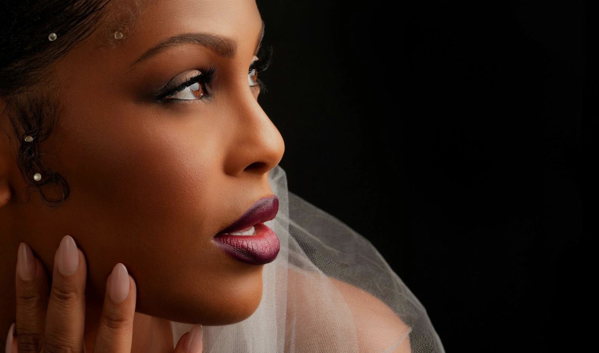 Close-up profile portrait against a dark background